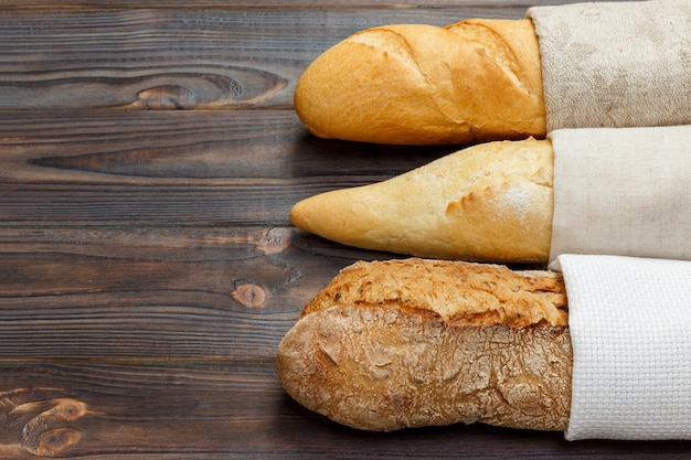 Assortment of fresh French baguettes on a wooden table