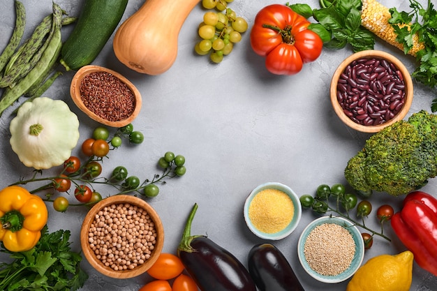 Assortment of fresh fruits and organic multicolored rainbow vegetables on gray concrete background. Food cooking and healthy clean food background and mock up.