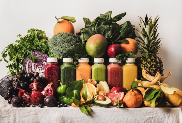 Assortment of fresh vegan smoothies and ingredients on table