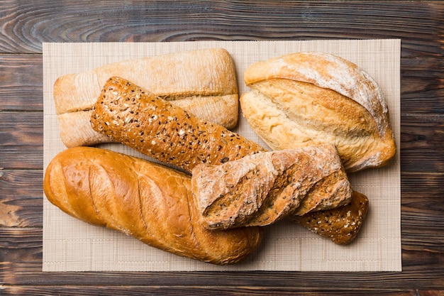 Assortment of freshly baked bread with napkin on rustic table top view Healthy unleavened bread French bread