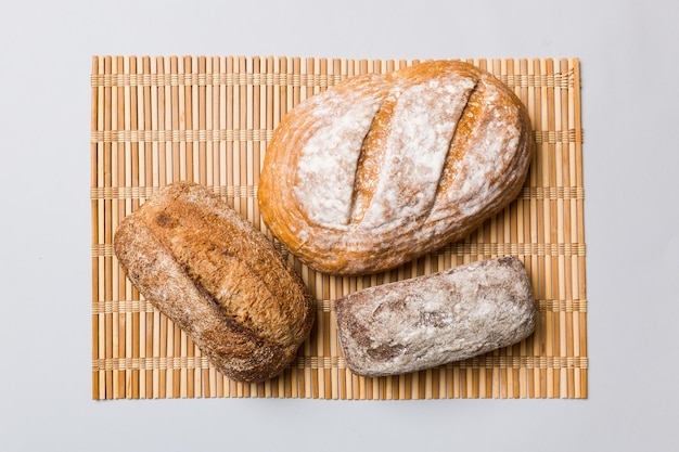 Assortment of freshly baked bread with napkin on rustic table top view Healthy unleavened bread French bread