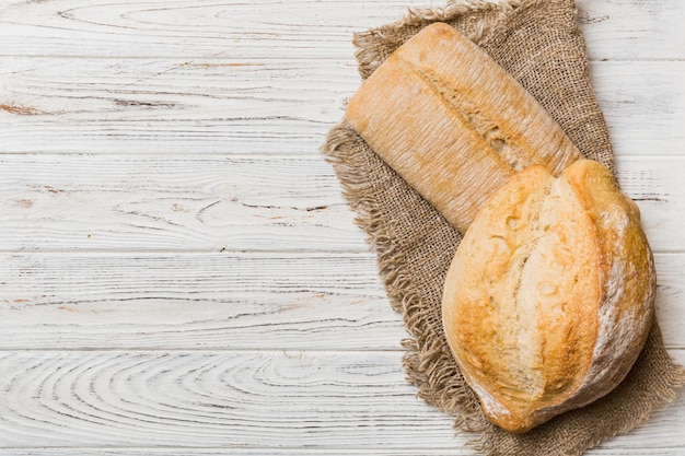 Assortment of freshly baked bread with napkin on rustic table top view Healthy unleavened bread French bread