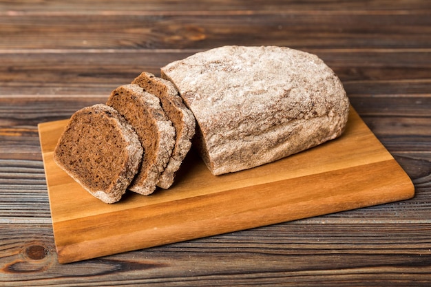 Assortment of freshly sliced baked bread with napkin on rustic\
table top view healthy unleavened bread french bread slice