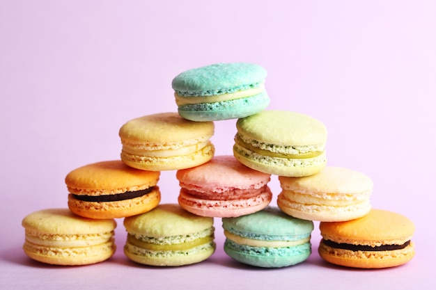 Assortment of gentle colorful macaroons on color surface