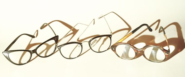 Assortment of glasses Glasses for lying on beige backgroundWomen's glasses glasses for student glasses for pensioner