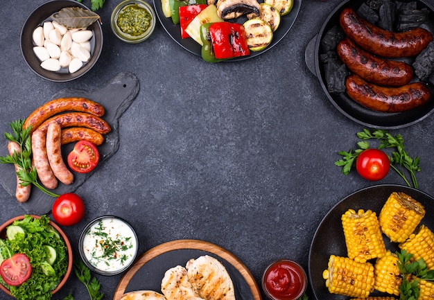 Assortment of grilled sausages, meat, and vegetables. Picnic barbeque concept