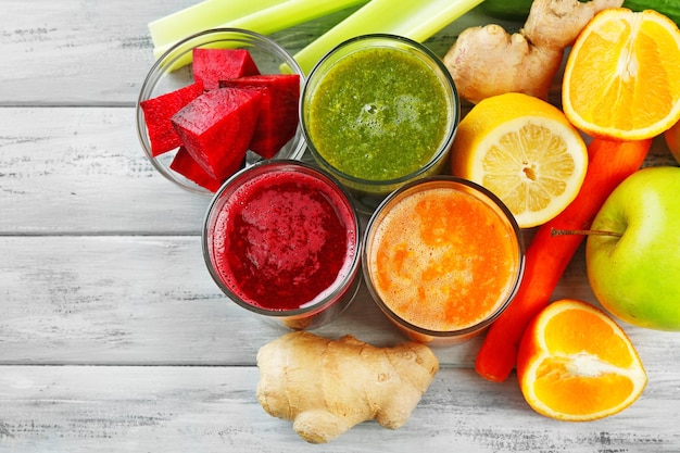 Photo assortment of healthy fresh juices on wooden table background