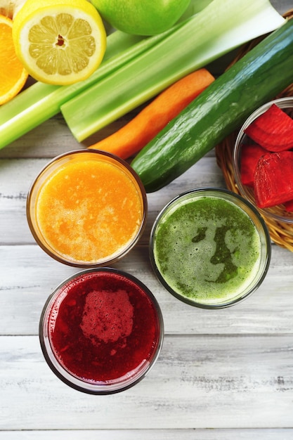 Assortment of healthy fresh juices on wooden table background