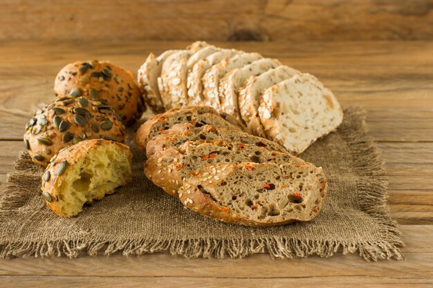 Assortment of Homemade Gluten-free vegan bread on the rustic wooden table. Homemade baked pastry.