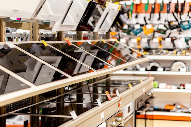 Assortment of induction cookers on a showcase of an electronic store on a blurred background