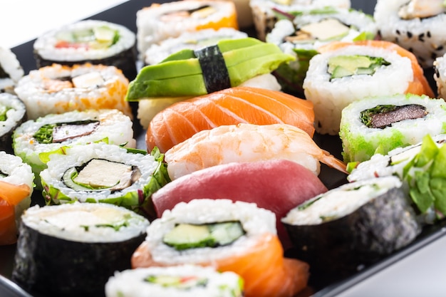 Assortment of japanese sushi rolls nigiri sashimi and maki.