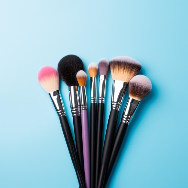 Assortment of makeup brushes with Blue Background