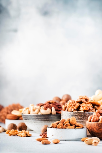 Assortment of nuts Cashews hazelnuts walnuts almonds etc Healthy Food Snacks mix on gray background copy space