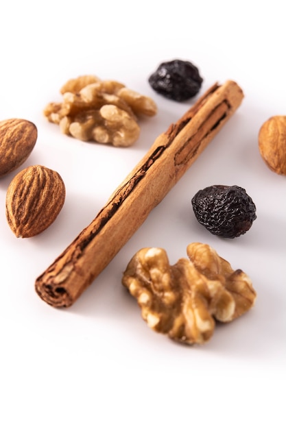 Assortment of nuts and cinnamon isolated on white