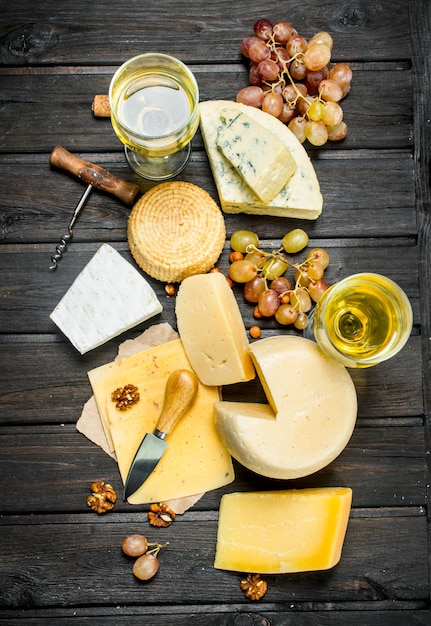 写真 ブドウと白ワインを使用したさまざまな種類のチーズの盛り合わせ