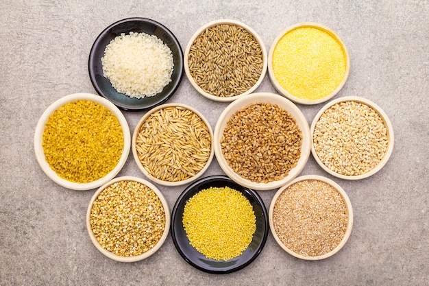 Assortment of organic cereals, legumes and whole grains in bowls