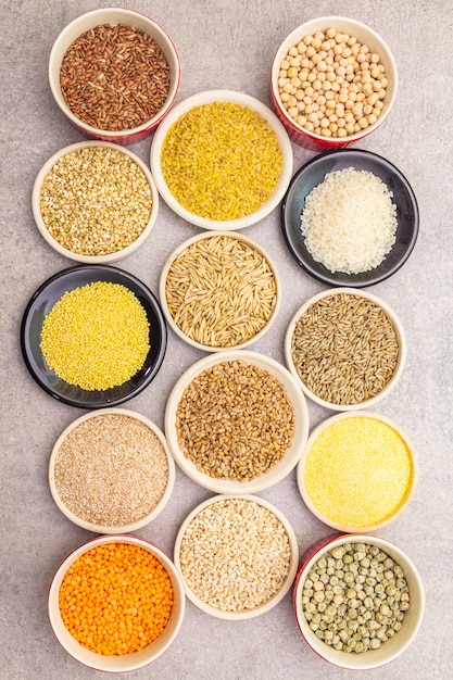 Assortment of organic cereals, legumes and whole grains in bowls