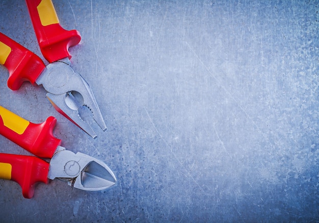 Assortment of pliers wirecutter on metallic background electric