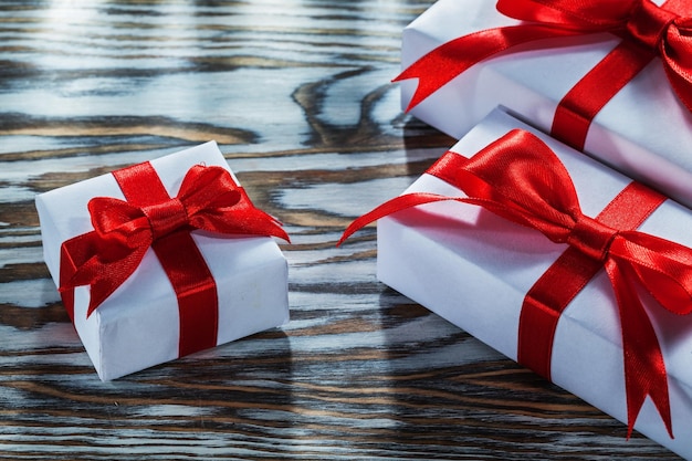 Assortment of red present boxes on wooden surface