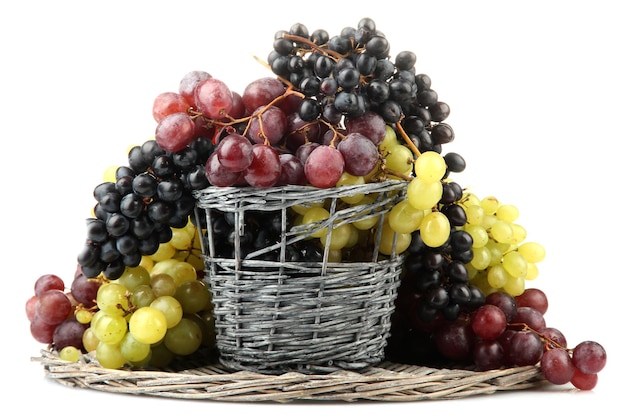 Assortment of ripe sweet grapes in basket isolated on white