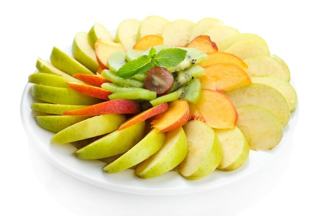 Assortment of sliced fruits on plate isolated on white