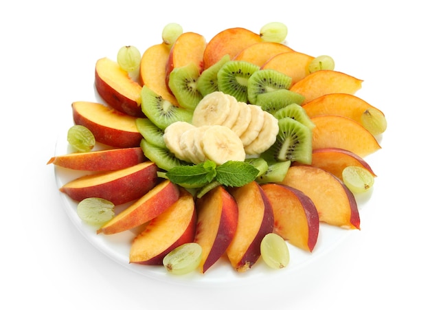 Assortment of sliced fruits on plate isolated on white