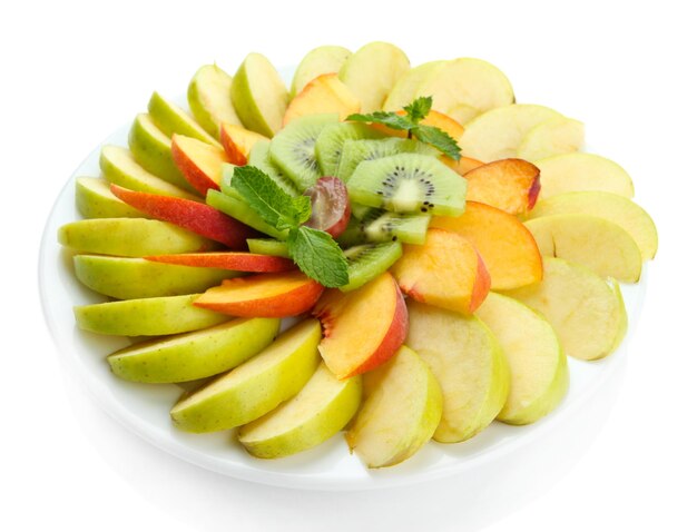 Assortment of sliced fruits on plate isolated on white