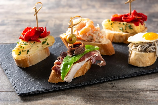 Assortment of Spanish pintxos on wooden table