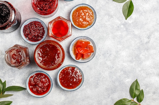 Assortment of sweet jams and seasonal fruits and berries,top view