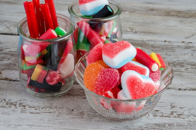 Assortment of sweets and candies in bowls on table