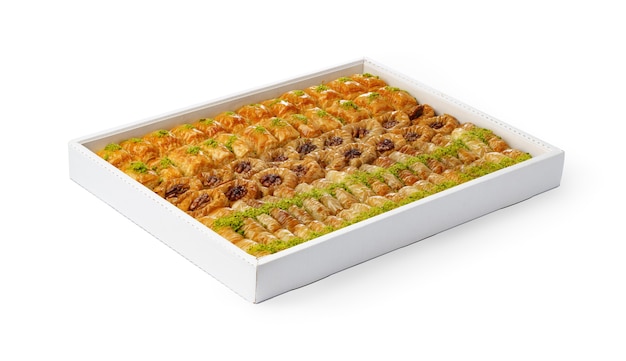 Assortment of Turkish baklava dessert in a white box isolated on white background