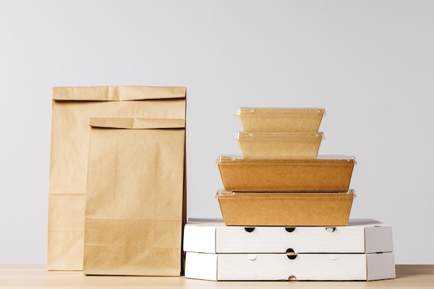 Assortment of various food delivery containers on table close up