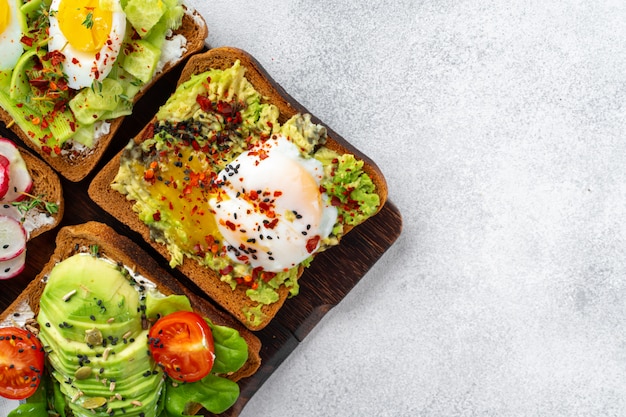 Assortment of vegan sandwiches with avocado and tomatoes