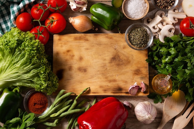 Assortment of vegetables herbs and spices on wooden table Top view Copy space