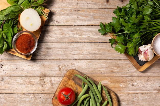 Assortment of vegetables herbs and spices on wooden table Top view Copy space