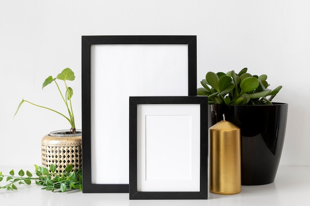 Photo assortment with different empty frames on table