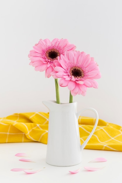 Assortment with pink flowers in a white vase
