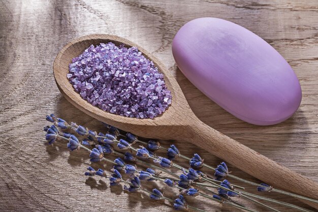 Assortment of wooden spoon crystal sea salt dry lavender bar of soap on wood board healthcare concept