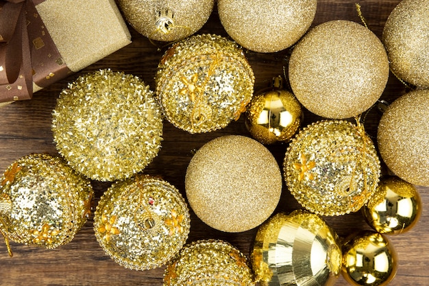 Assortments of gold Christmas ornamental baubles and a present box