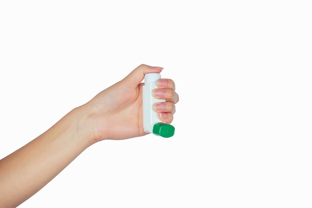 Asthma inhaler in hand on white isolate