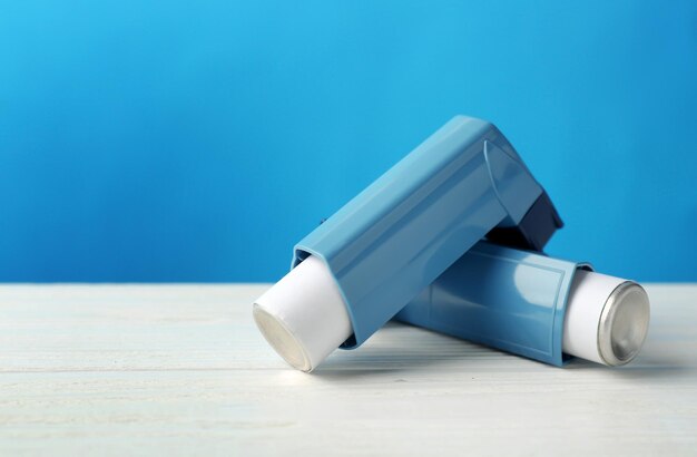 Asthma inhalers on blue background