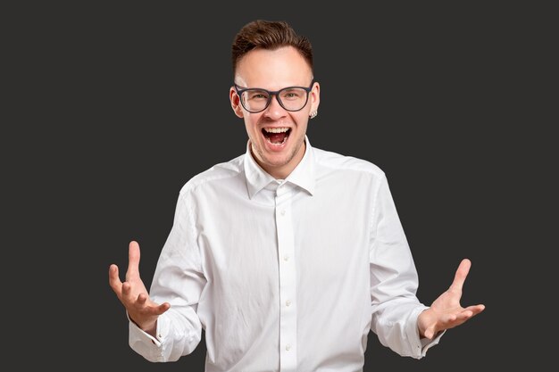 Astonished man portrait Exciting opportunity Amazed millennial guy yelling happy to win professional competition isolated on black Successful startup Unbelievable luck