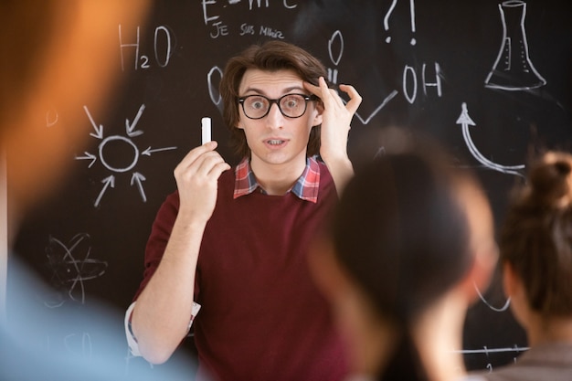 Astonished teacher with a chalk