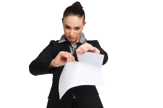 Astonished woman tearing a document apart. Isolated on white