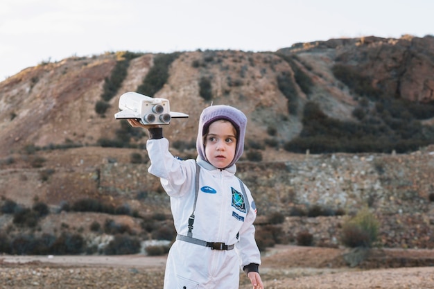 Astronaut girl playing in nature