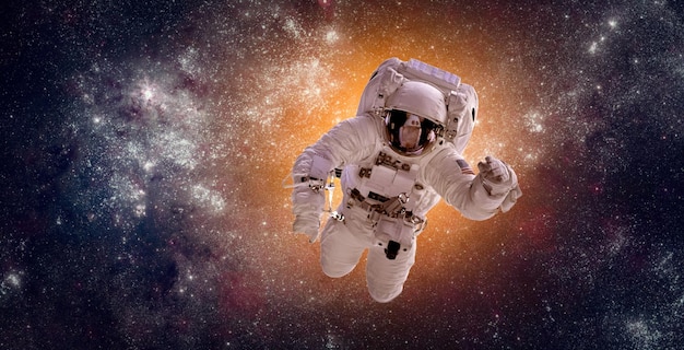 Astronaut in outer space against the backdrop of the planet earth. Elements of this image furnished by NASA.