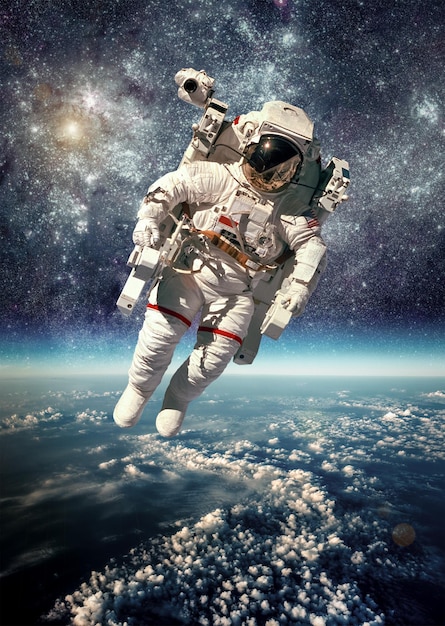 Astronaut in outer space against the backdrop of the planet earth. Elements of this image furnished by NASA.