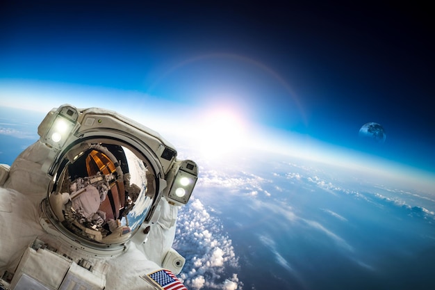 Astronaut in outer space against the backdrop of the planet earth. Elements of this image furnished by NASA.