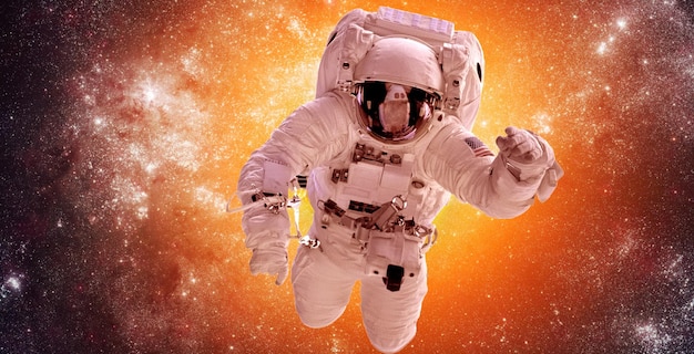 Astronaut in outer space against the backdrop of the stars nebula background. Elements of this image furnished by NASA.