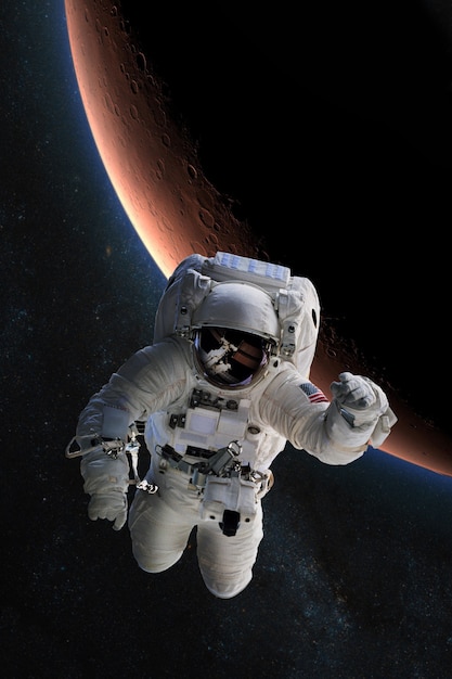 Astronaut in outer space on background of the Mars planet